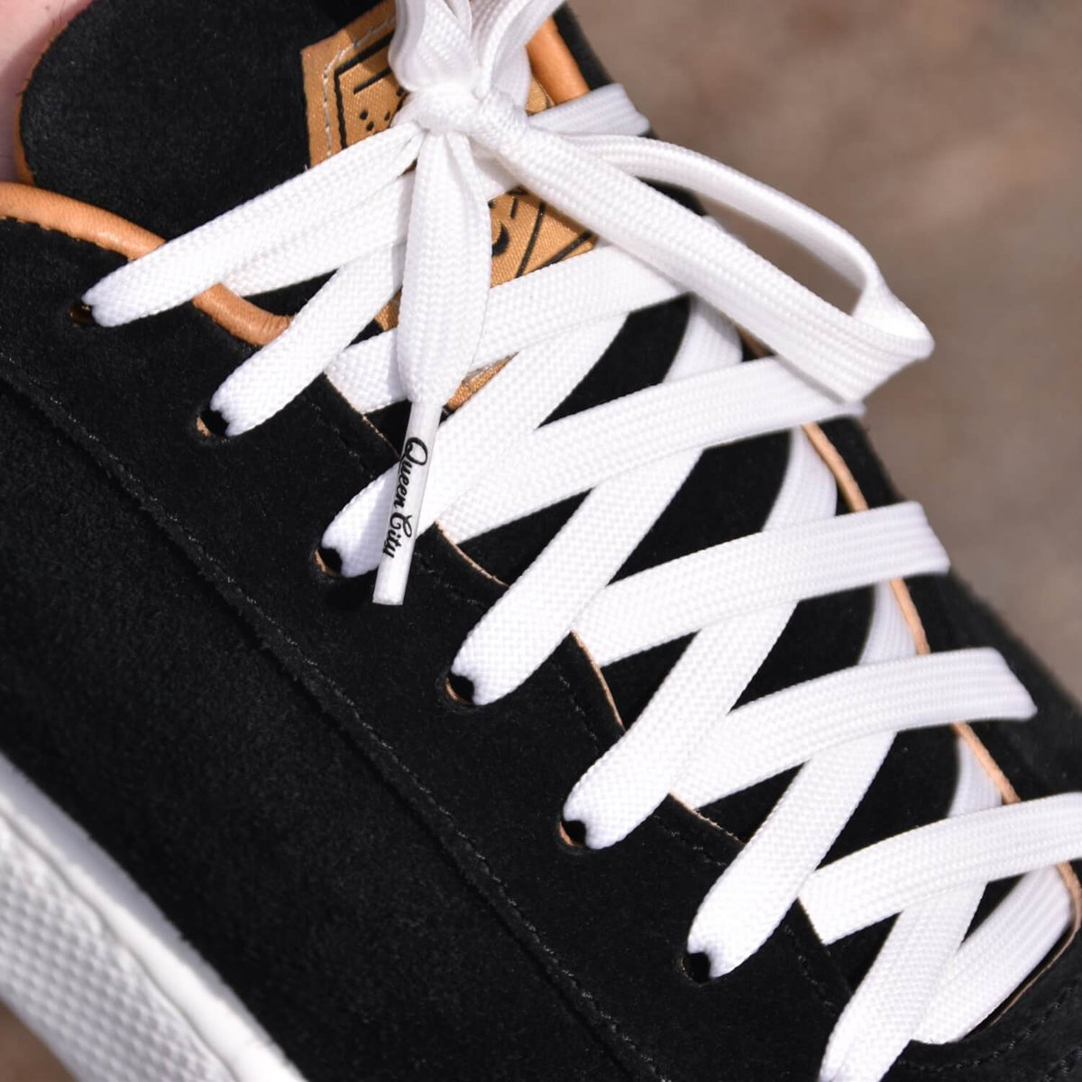 Close up view of black Hardwick sneaker with white laces