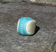 Blue and silver footbag on a rock wall
